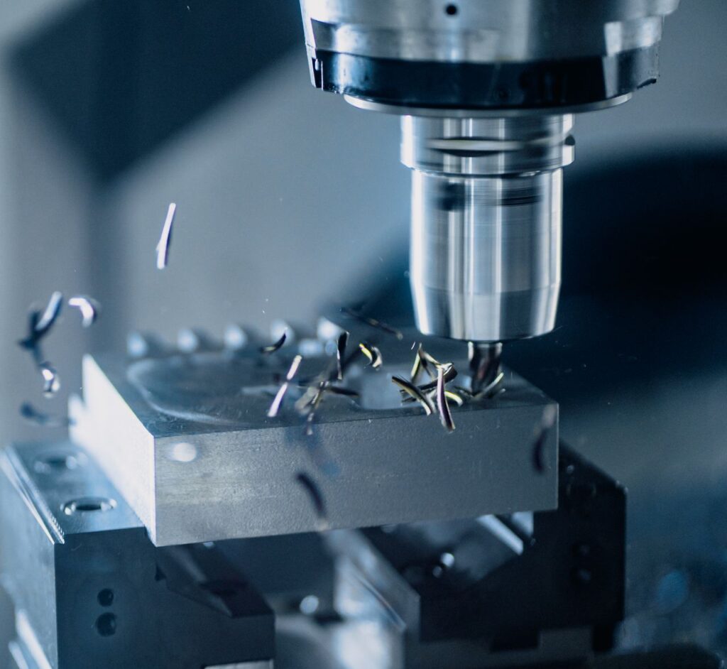 Services Close-up of a CNC milling machine working on metal for precise manufacturing.